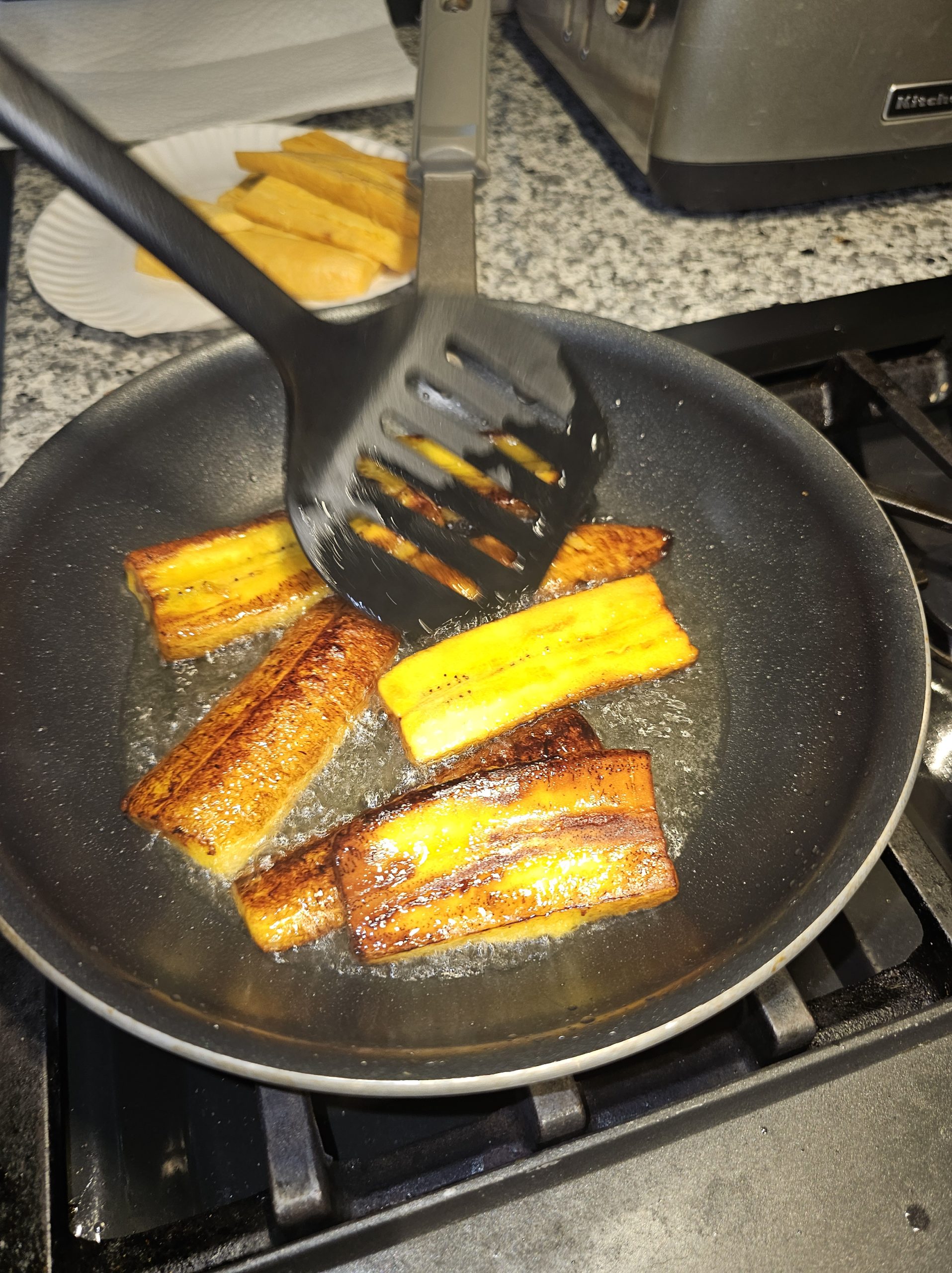 Fried Plantains in pan with spatula
